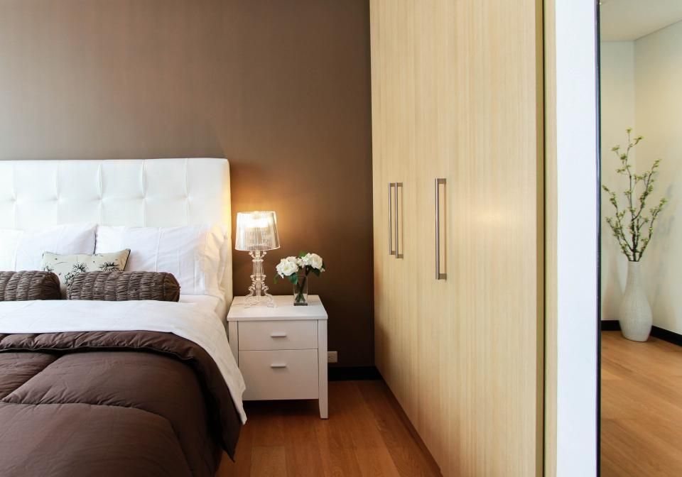 A guest room with a large bed and soft lighting